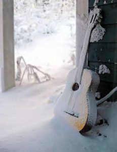 Acoustic guitar in winter snow | Writer Mariecor | WriterMariecor.com