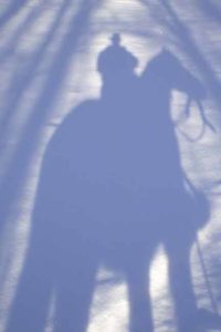 Winter shadow of cowboy and horse | Writer Mariecor | WriterMariecor.com